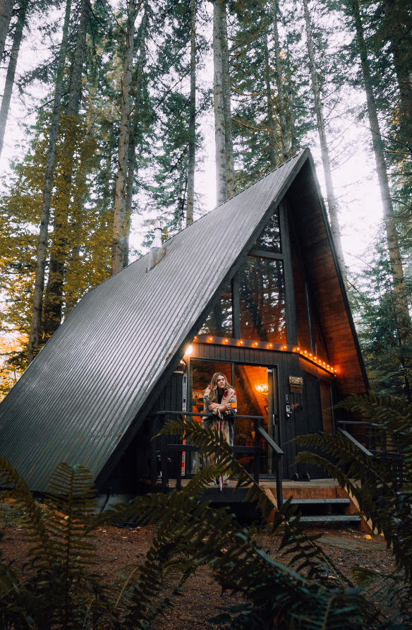 woman standing on porch of treehouse